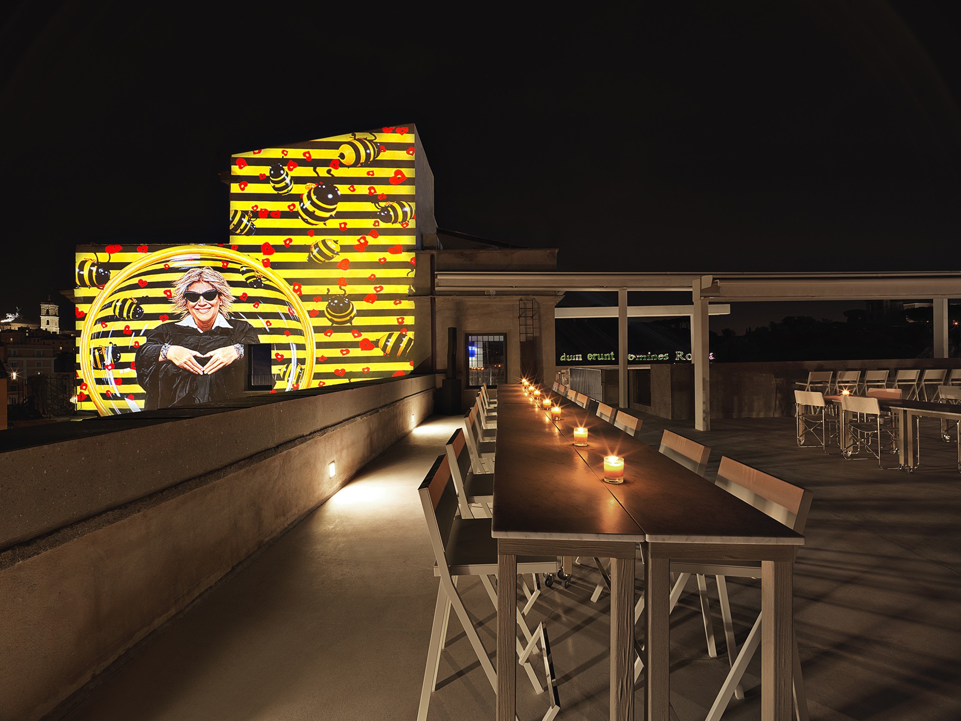 Terrace with an art projection at night at Retrobottega