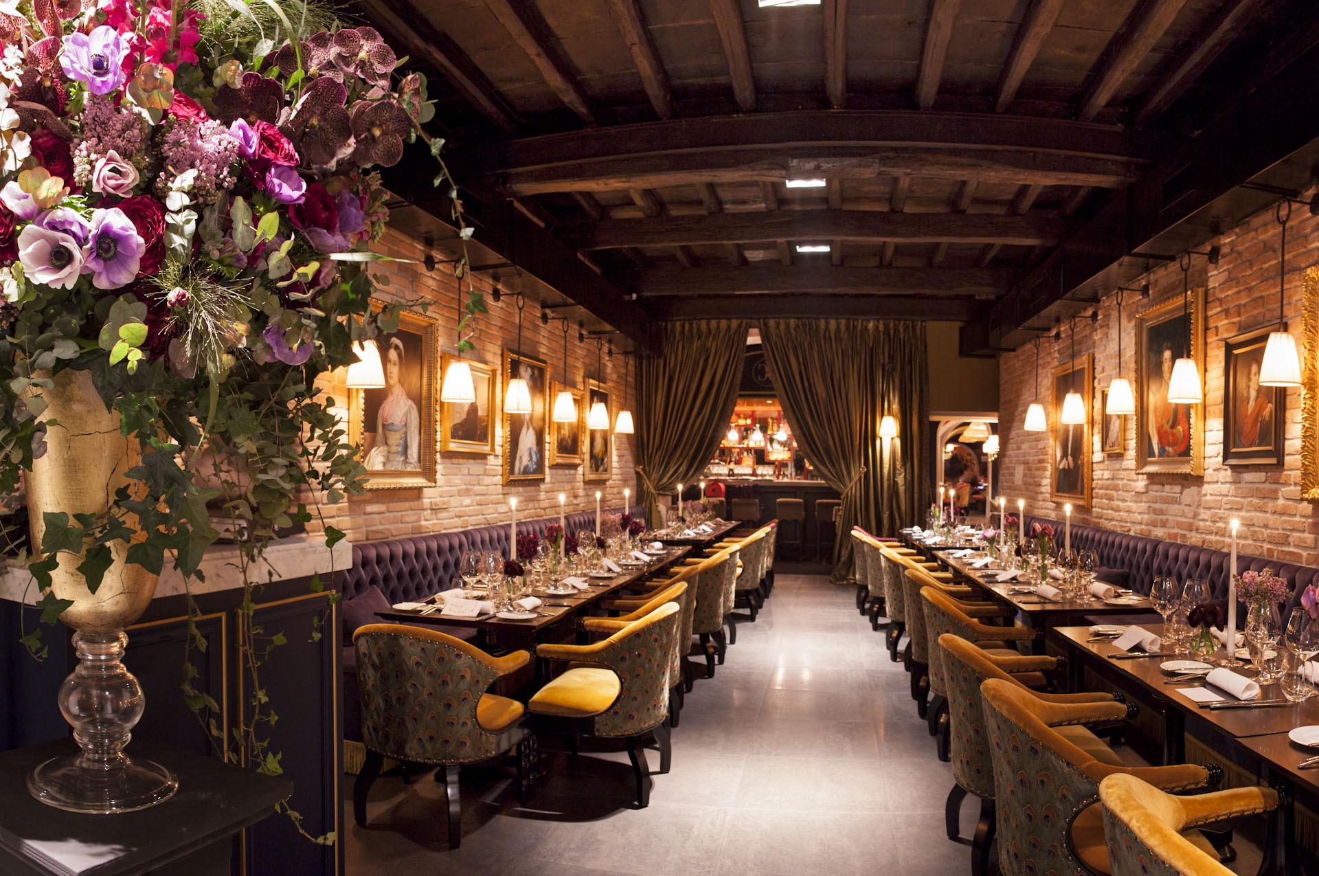 Main dining room with paintings and floral arrangements at Casa Coppelle