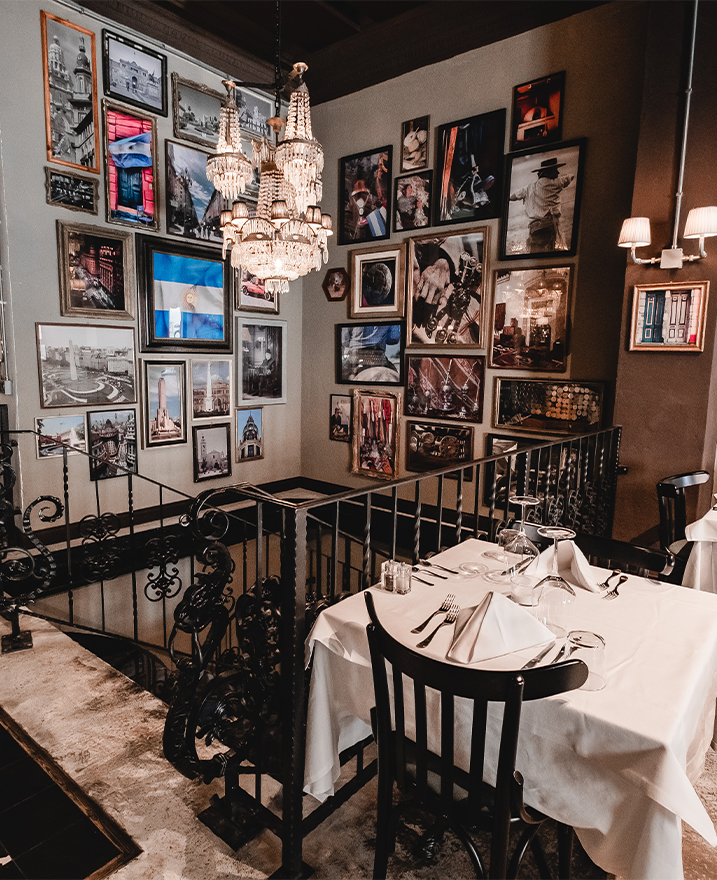 Staircase and framed photographs at El Porteno Teatro Valle