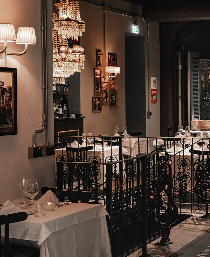 Dining tables beside the staircase at El Porteno Teatro Valle