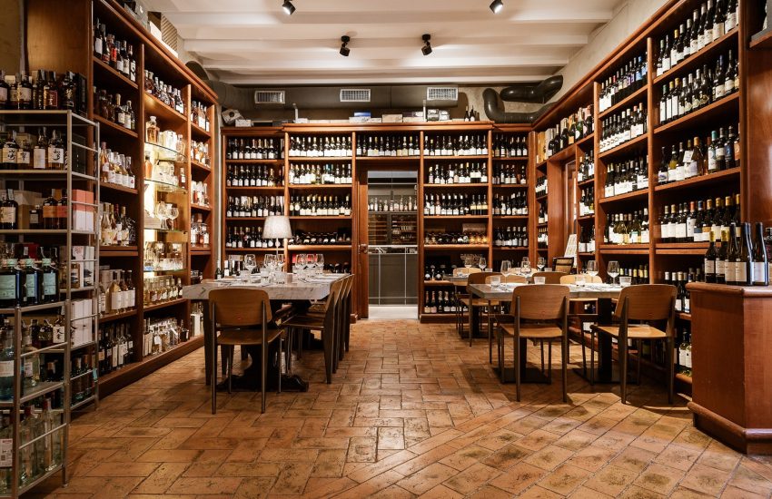 Dining room surrounded by wine bottles at Del Frate