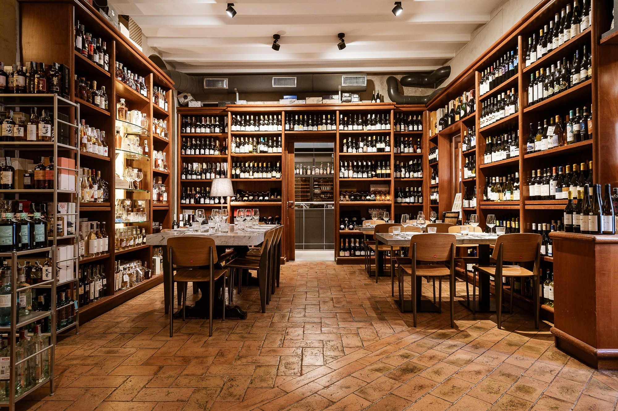 Dining room surrounded by wine bottles at Del Frate