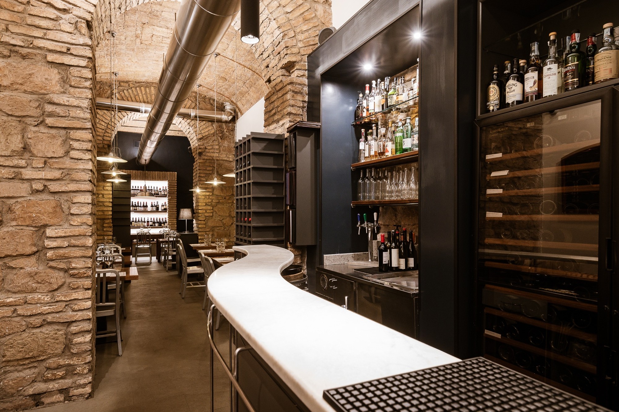 Bar beneath brick arches at Del Frate