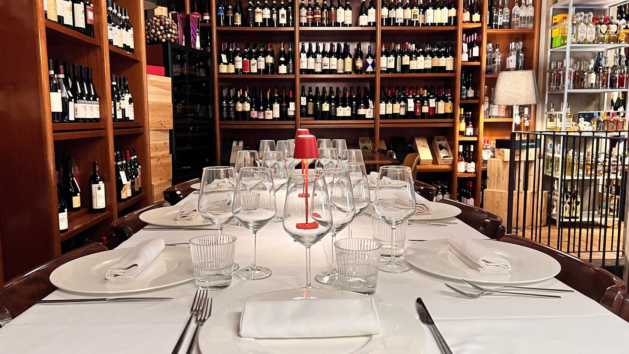 Table set among wine shelves at Del Frate