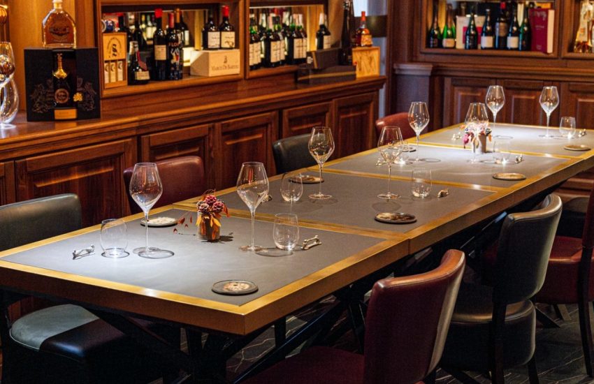 Dining table surrounded by wooden wine cabinets at Achilli al Parlamento