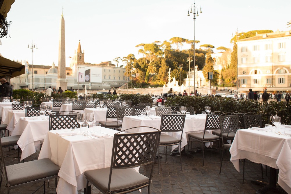 Outdoor tables overlooking Piazza del Popolo at Dal Bolognese Roma