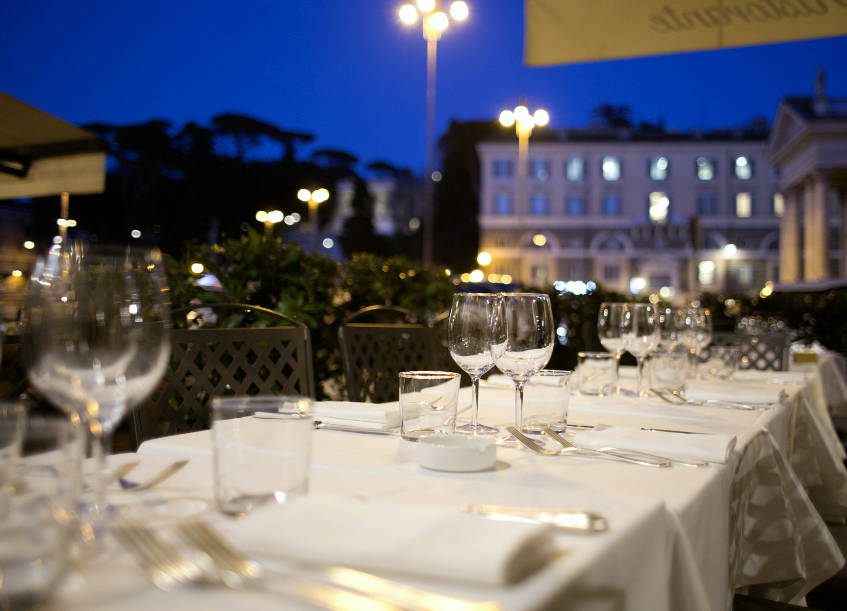 Outdoor table at dusk at Dal Bolognese Roma
