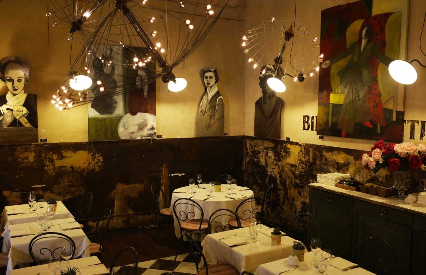 Dining room with artworks and pendant lights at Babette