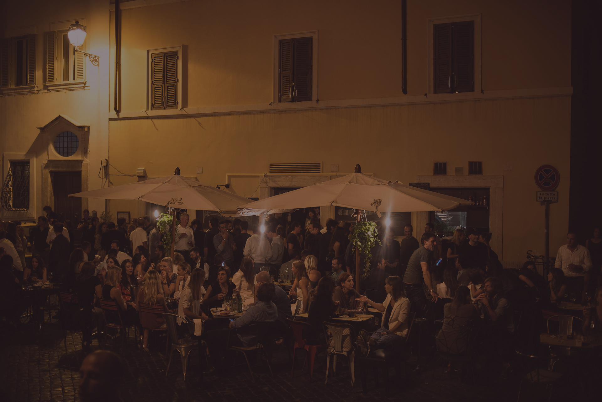 Outdoor dining in Piazza delle Coppelle at night at Osteria delle Coppelle