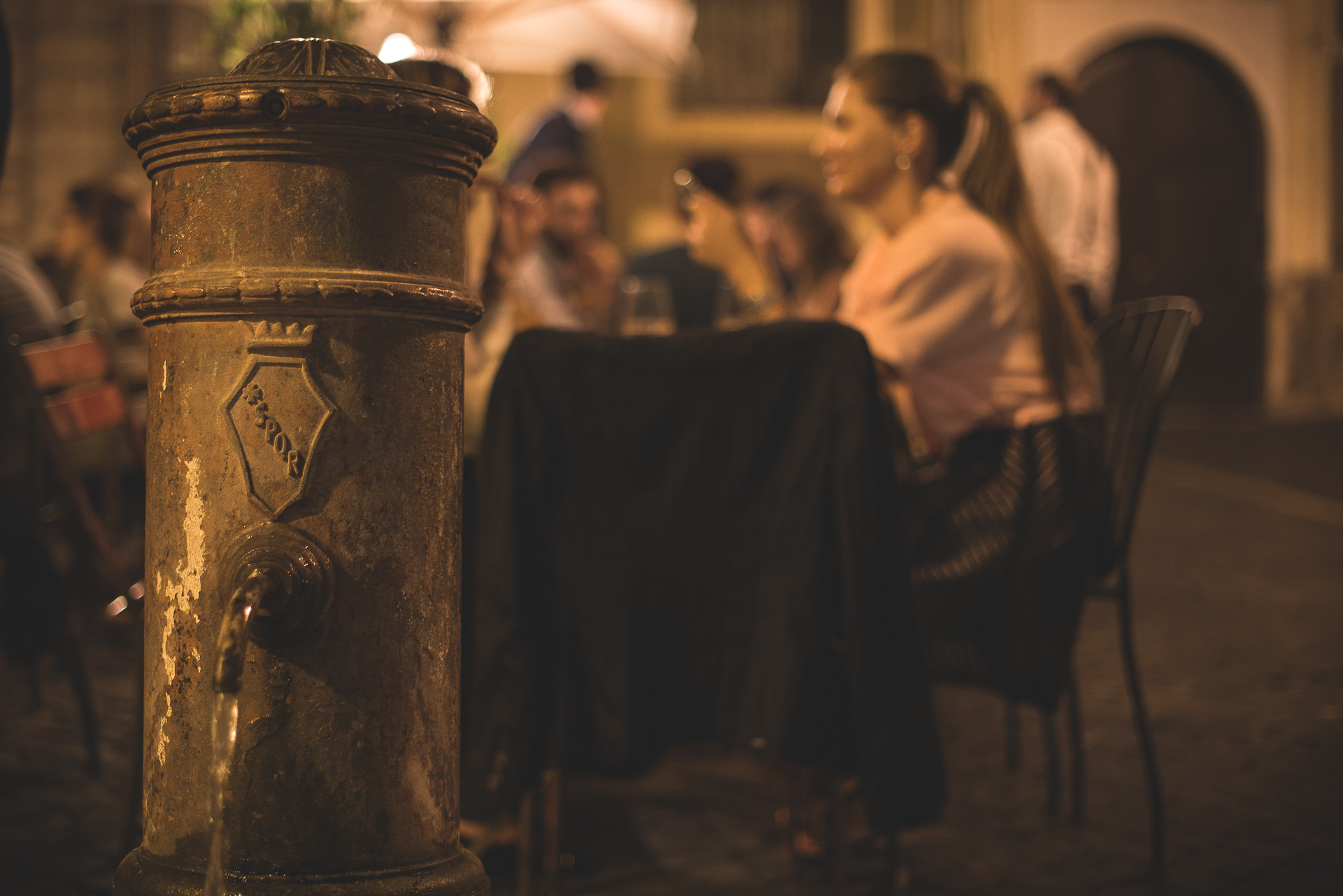 Roman fountain beside outdoor tables at Osteria delle Coppelle