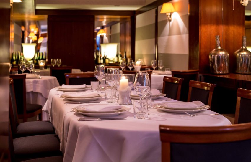 Dining room with candlelit tables at Ai Piani