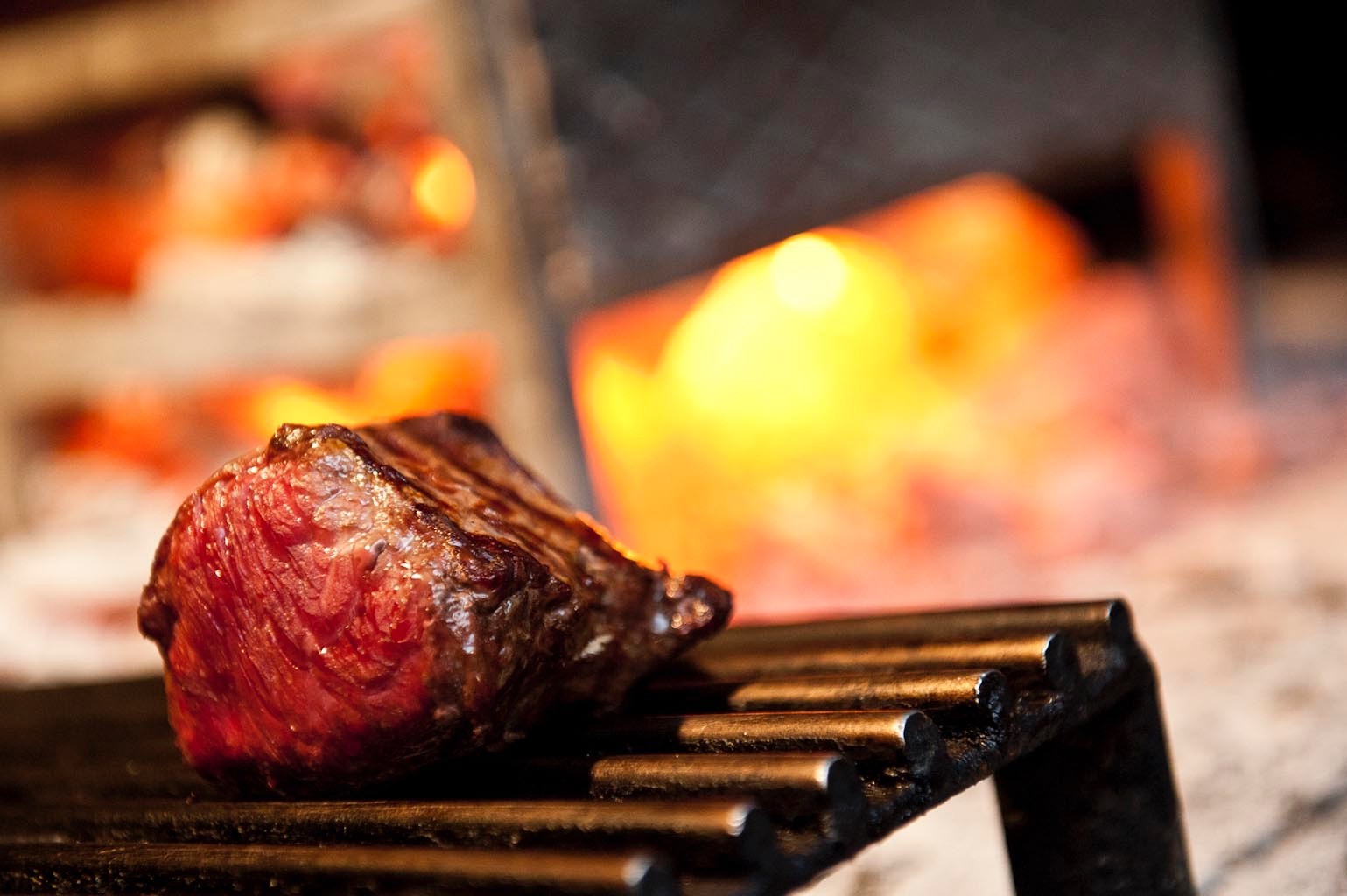 Meat cooking on the grill at Al Ceppo